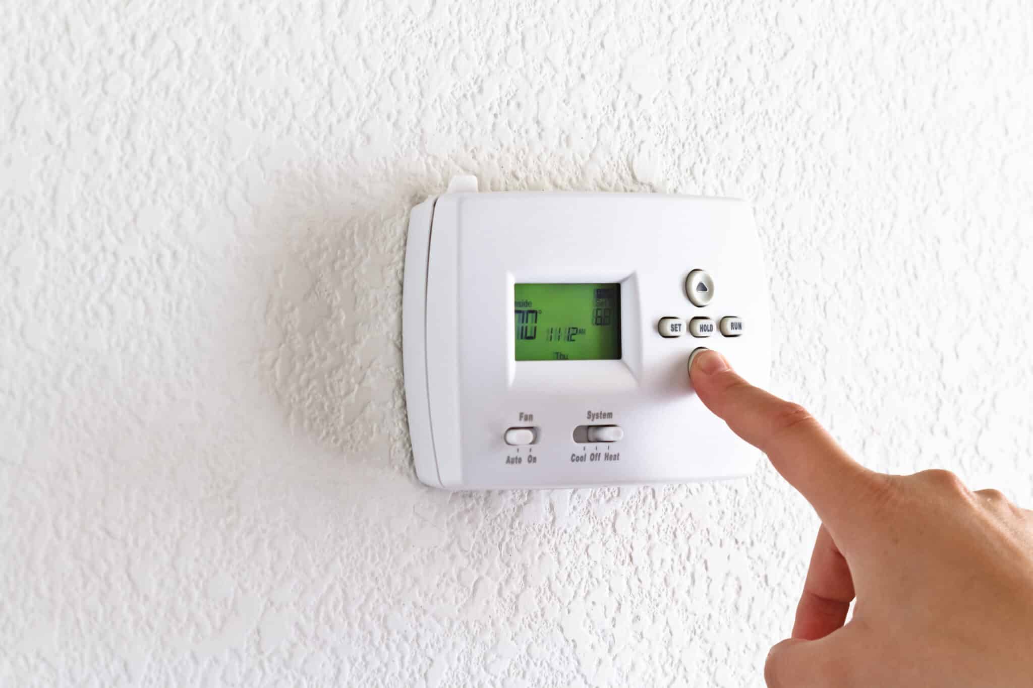 Thermostat with finger pressing button, Smarter Maintenance.